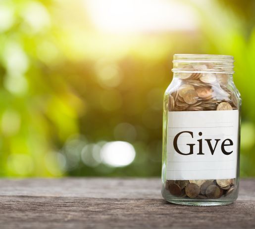 Jar of coins that says Give on it